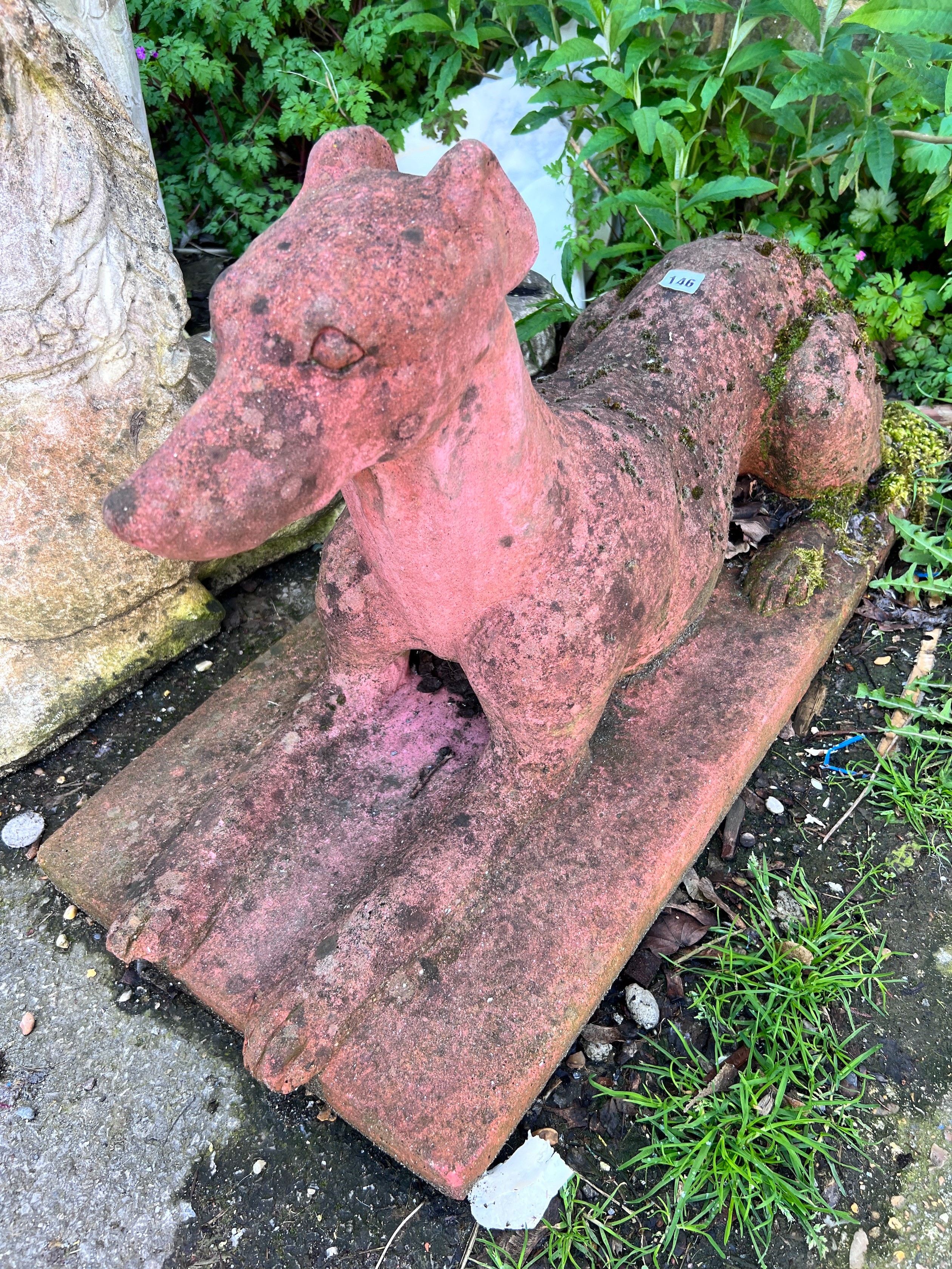 A terracotta recumbent greyhound garden ornament, height 40cm *Please note the sale commences at 9am.